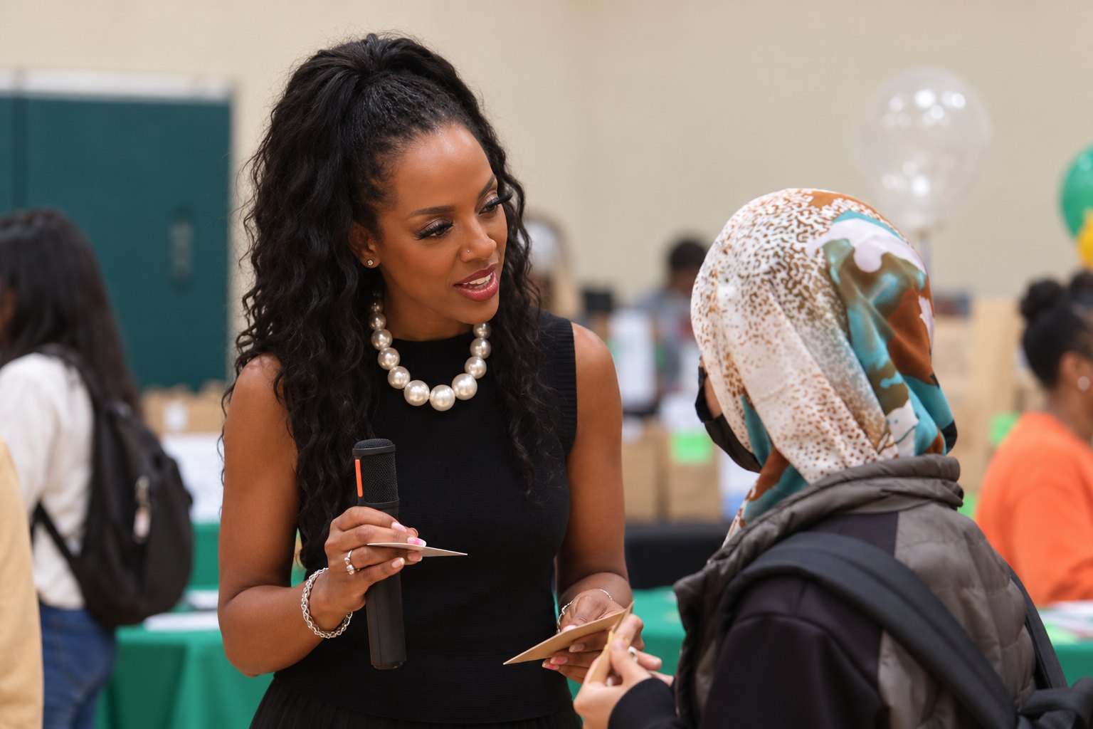 Dr. Cherone speaking with a student at a school event